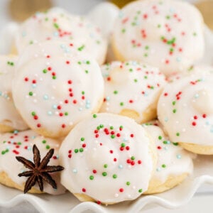 White sugar glazed Italian Christmas Cookies with red, green, and blue sprinkles on top.