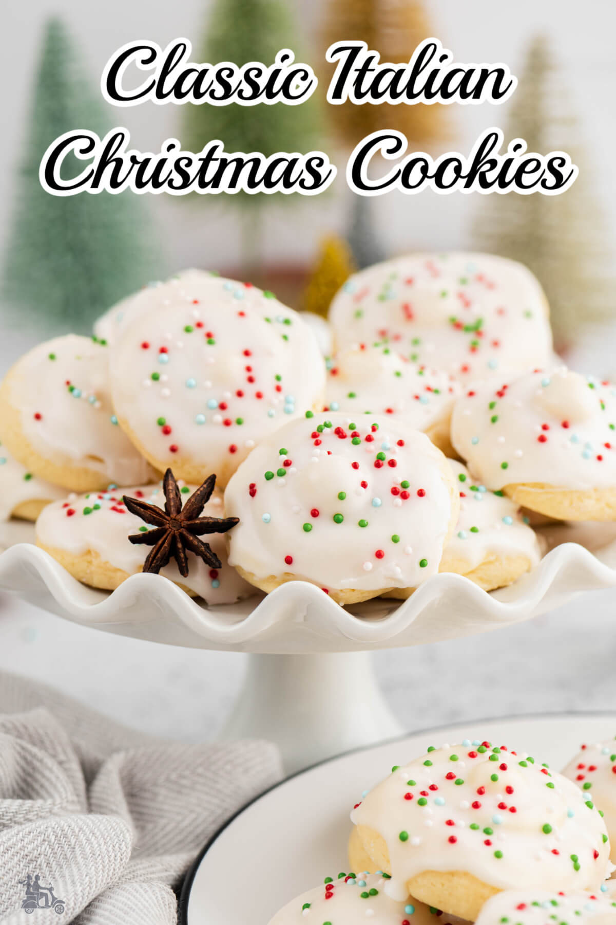Classic Italian Christmas cookies with white glaze and colored sprinkles in a white pedestal candy dish. 