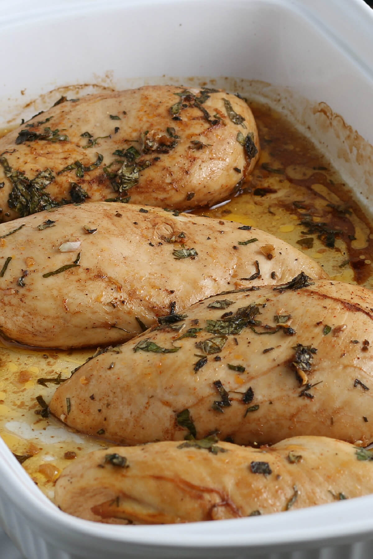 Roasted chicken breast in baking dish waiting to be served. 