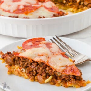 Closeup of a slice of spaghetti pie with the casserole in the background.