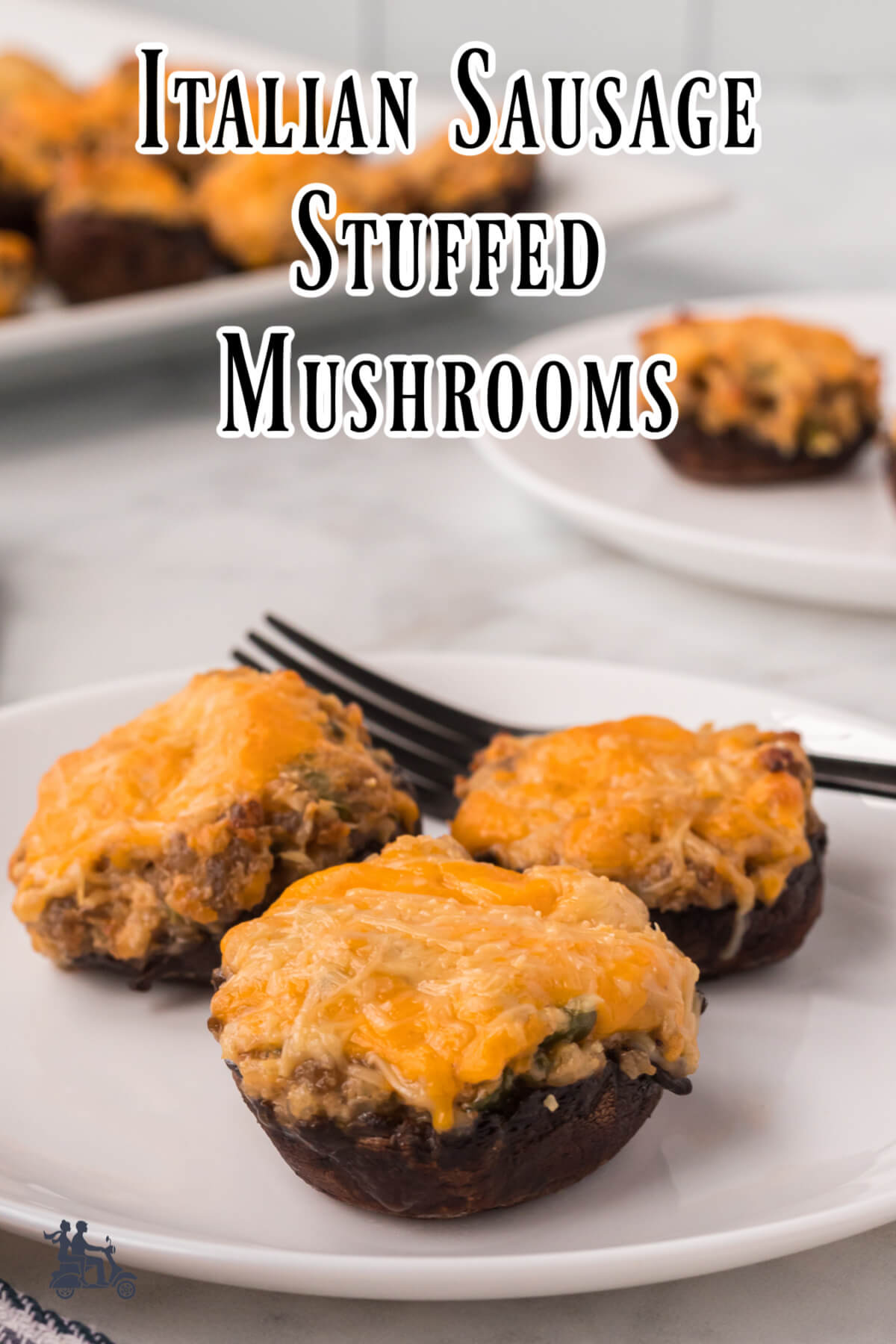 Stuffed mushroom caps on a white plate with more plates with mushrooms in the background.