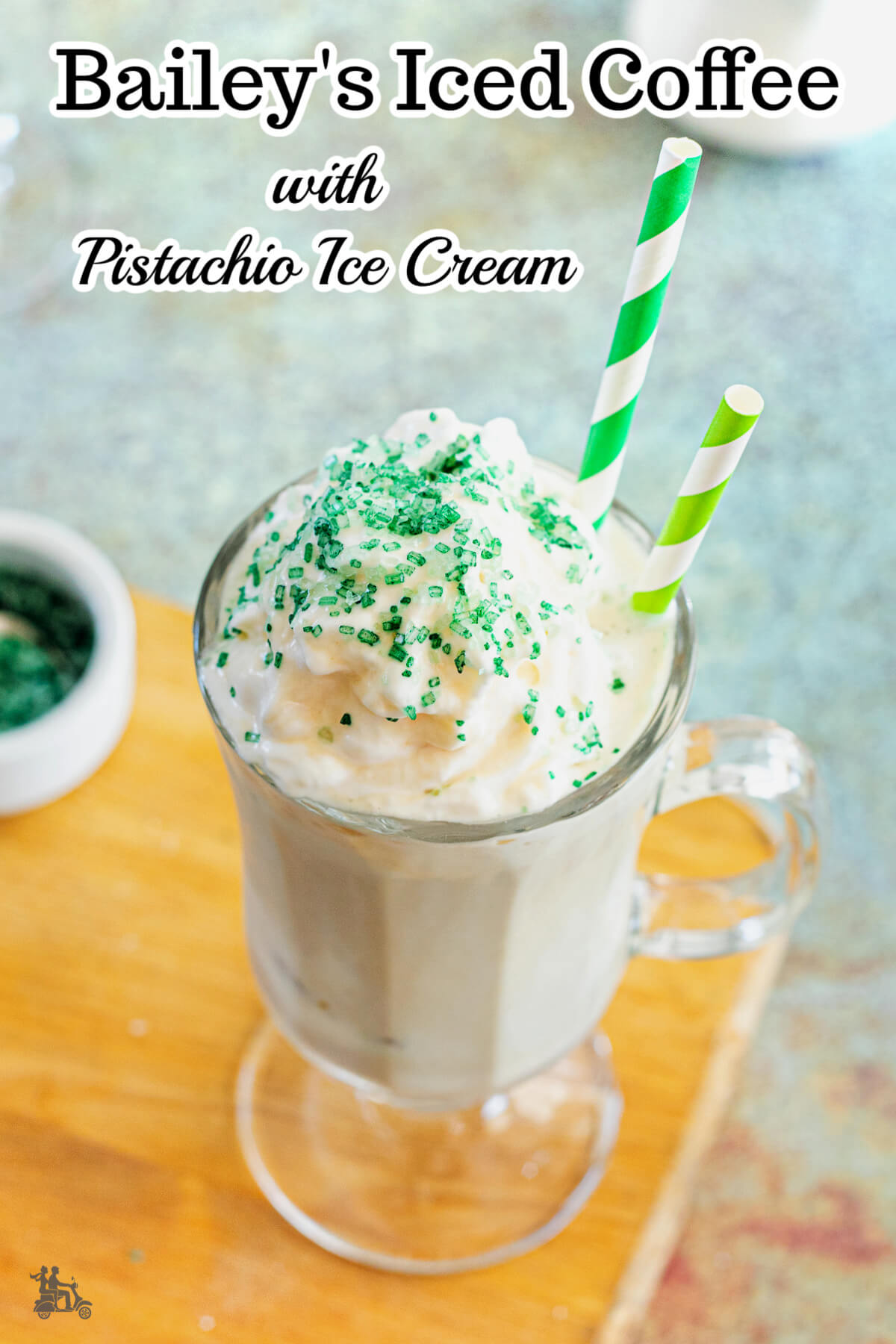 Overhead view of Iced Coffee with ice cream and has two straws in an Irish Coffee glass mug. 