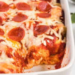 Casserole dish filled with Bubble Pizza Bread and a serving removed.