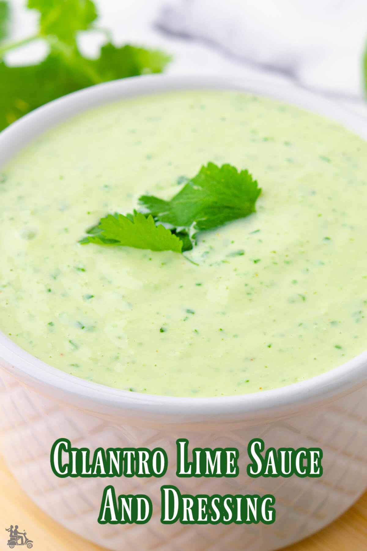 A closeup of cilantro lime dressing in a white bowl. 