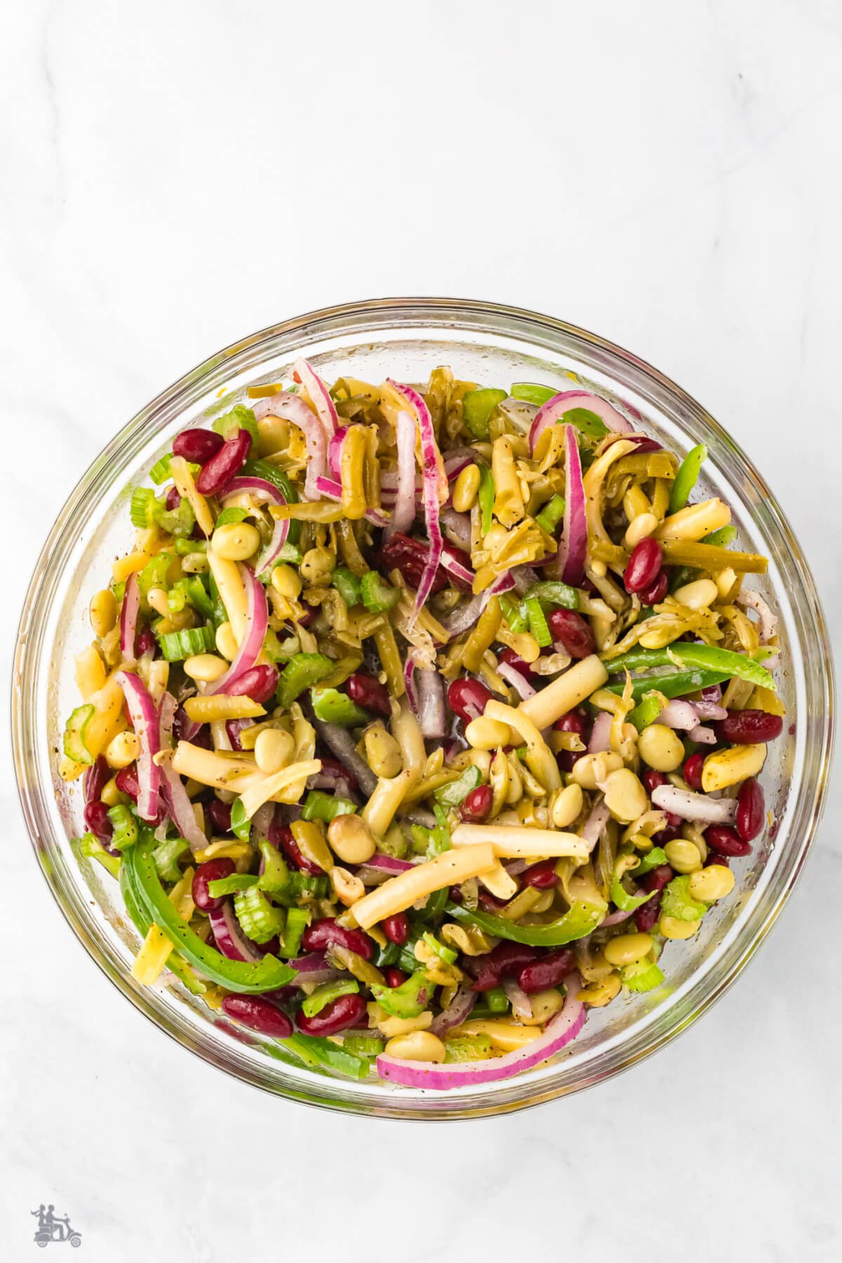 Combination beans in a glass bowl with celery and onion. 