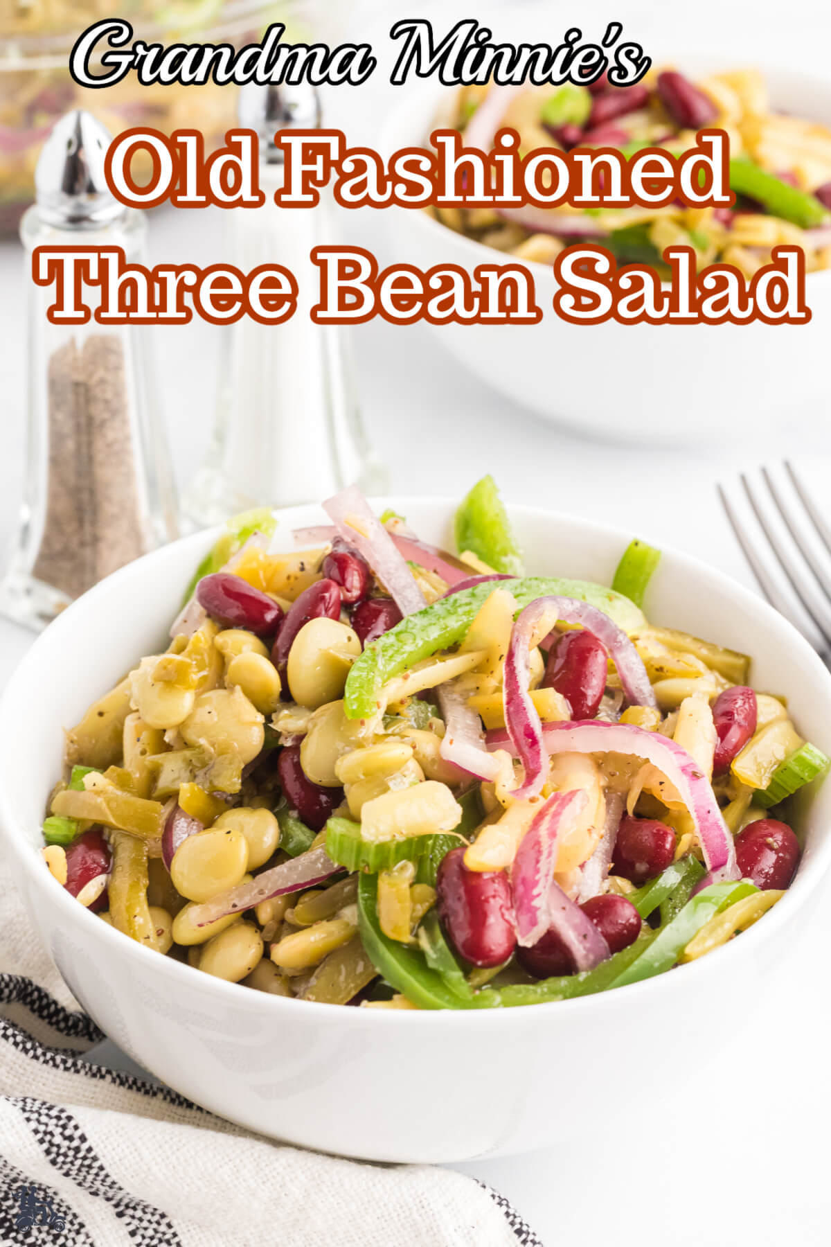 A white bowl filled with three bean salad. 