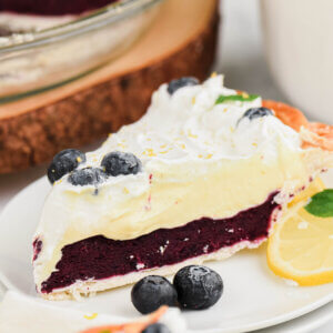 Slice of Blueberry Pie with a top creamy layer.