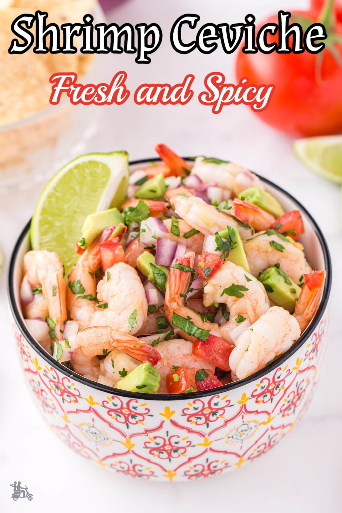 A bowl filled with shrimp ceviche with lime and avocado. 