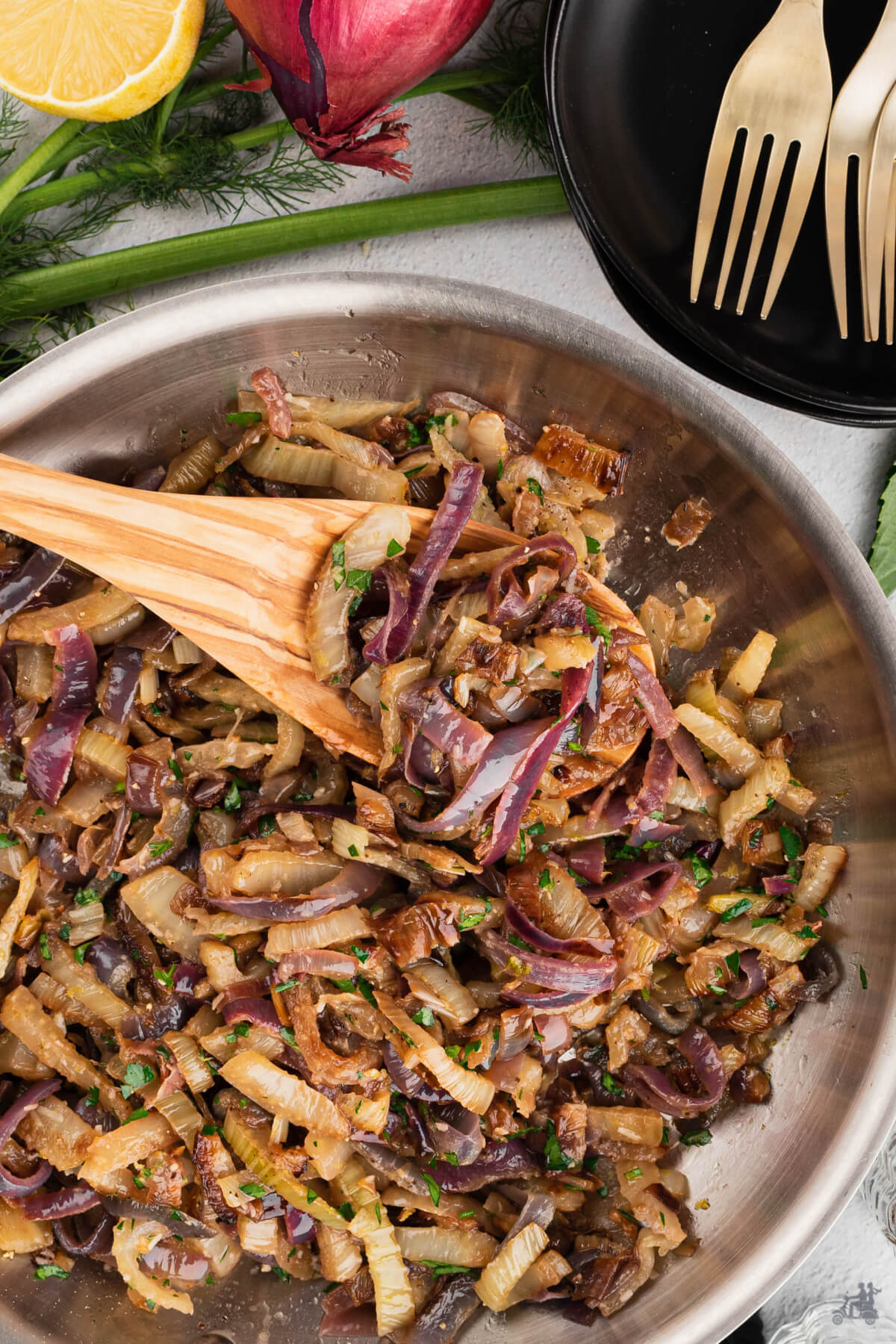 Pan roasted fennel and onion with a wooden spoon. 