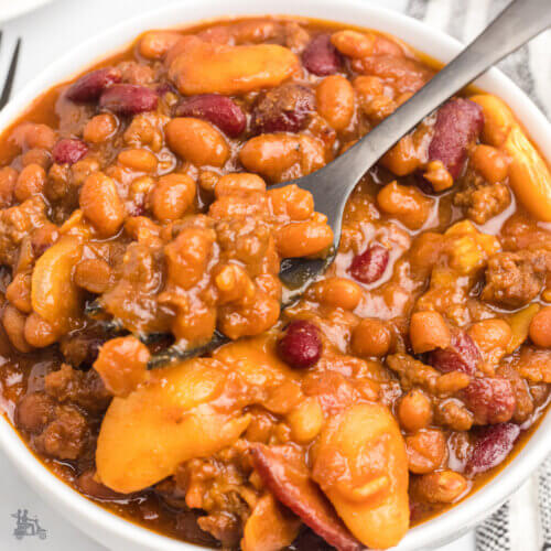 Bowl of Old Settler Baked Beans made Cowboy Style with Barbecue Sauce.