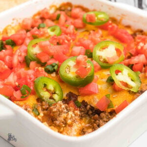 Casserole dish with baked ground beef taco dip.