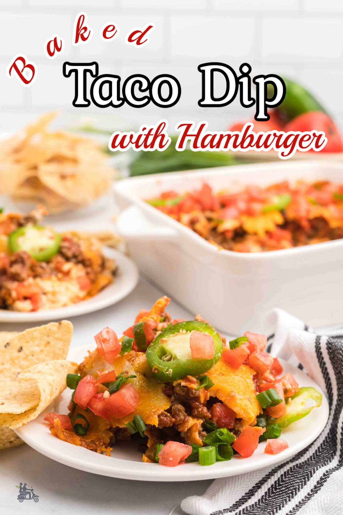 A serving of Hamburger Taco Dip with tortilla chips on table. 