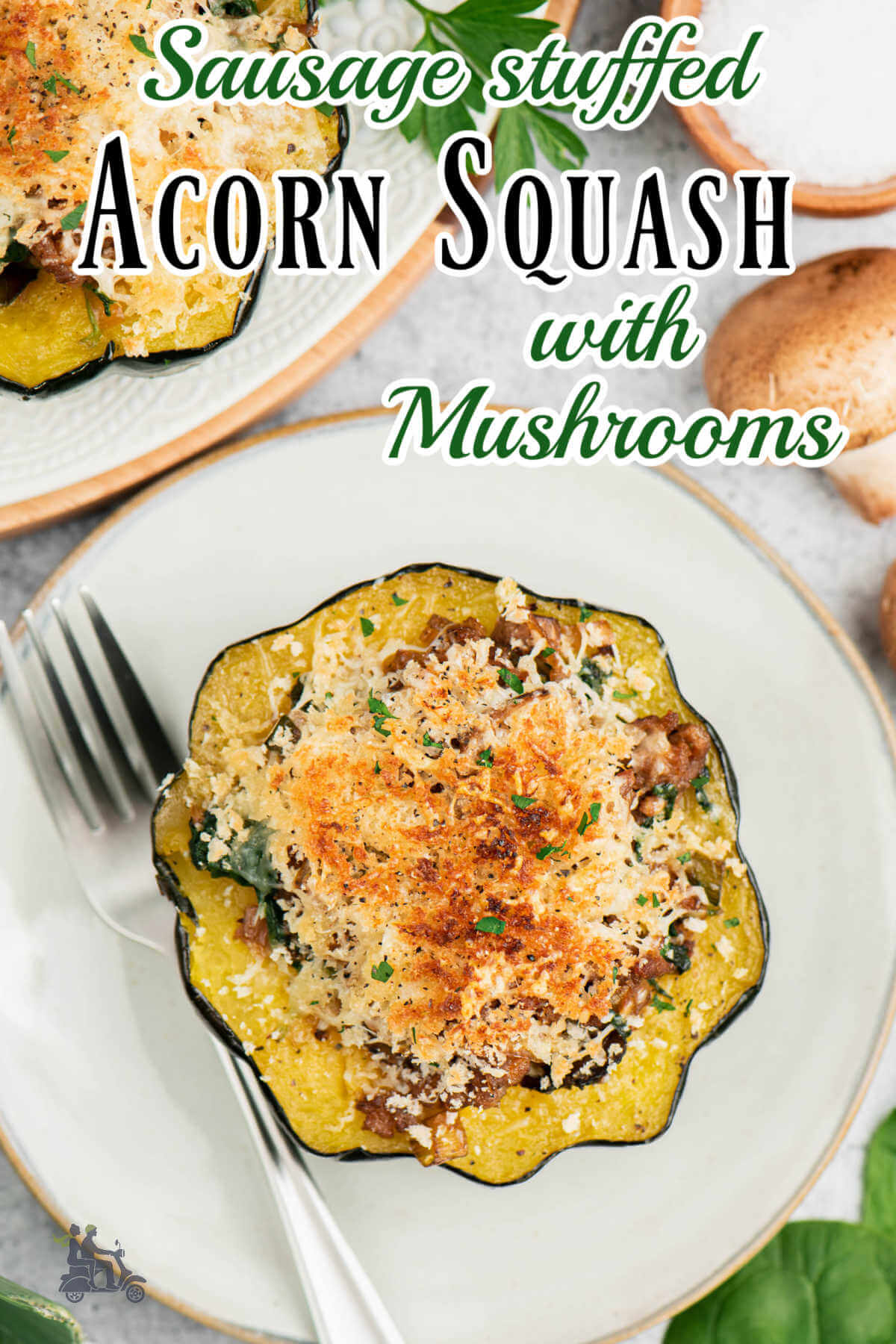 Baked sausage stuffed acorn squash with mushrooms on a white plate with a fork on the side. 