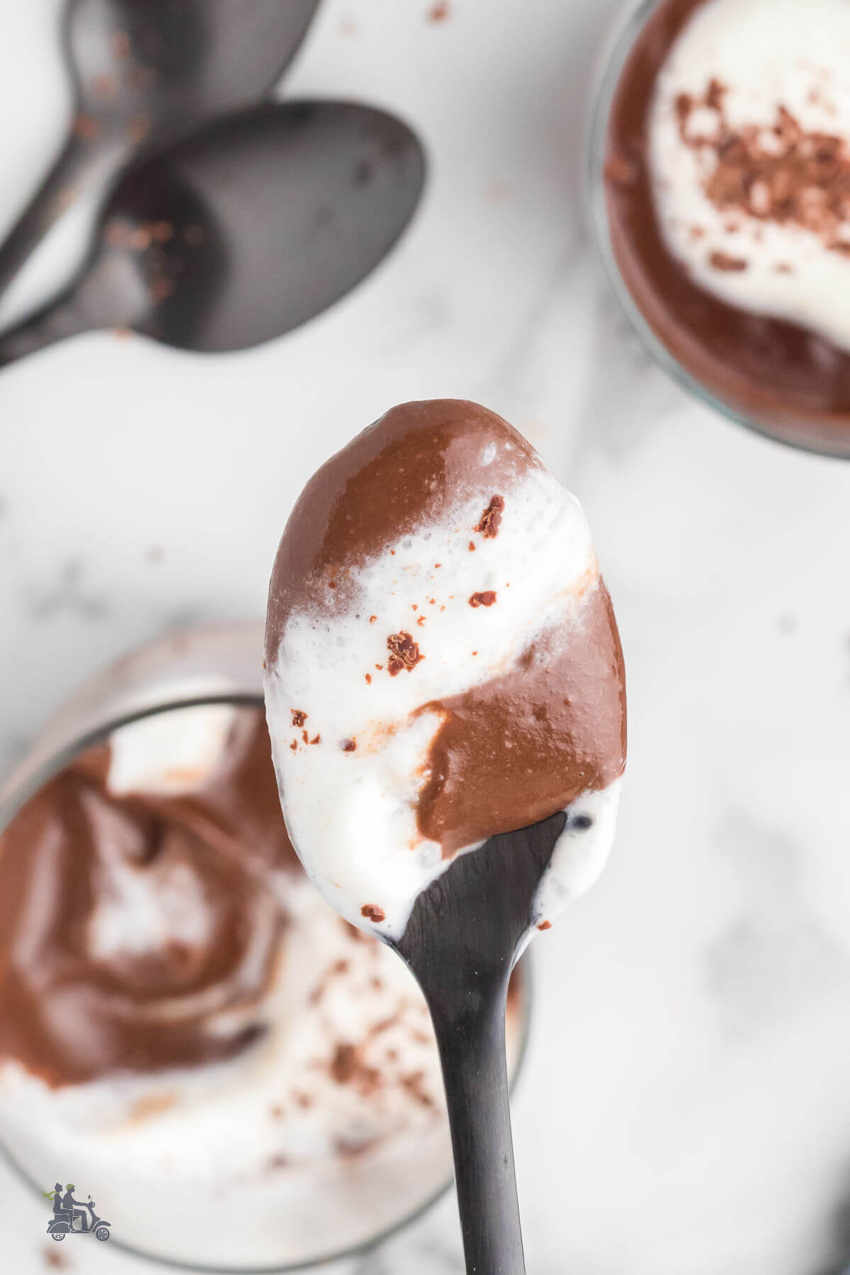 A spoonful of rich and creamy Italian chocolate pudding with whipped cream topping. 