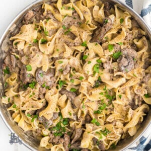 A skillet filled with stroganoff made with ground beef and egg noodles.