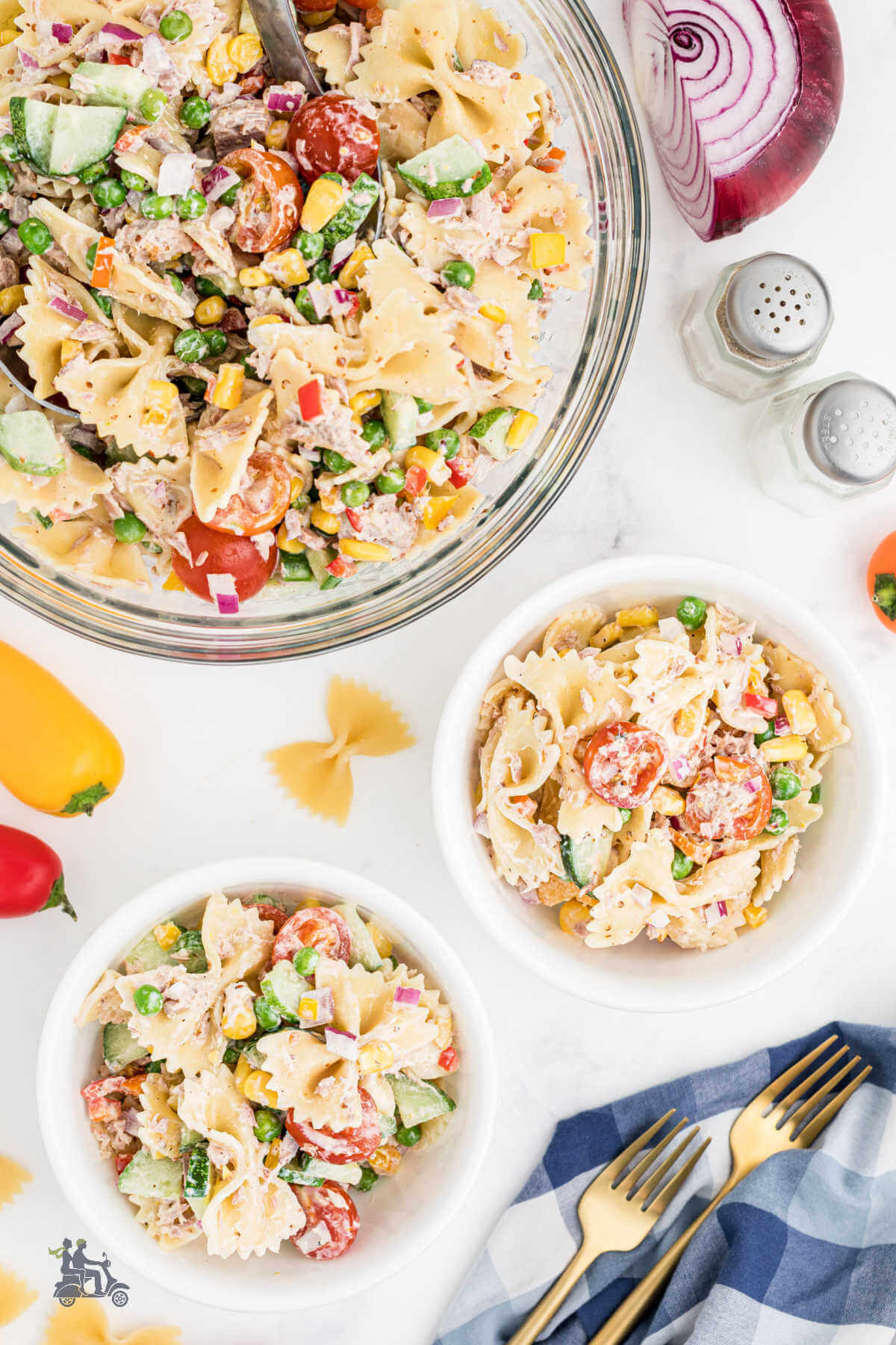 Two bowls of Cold Tuna Pasta Salad with the big bowl next to it. 