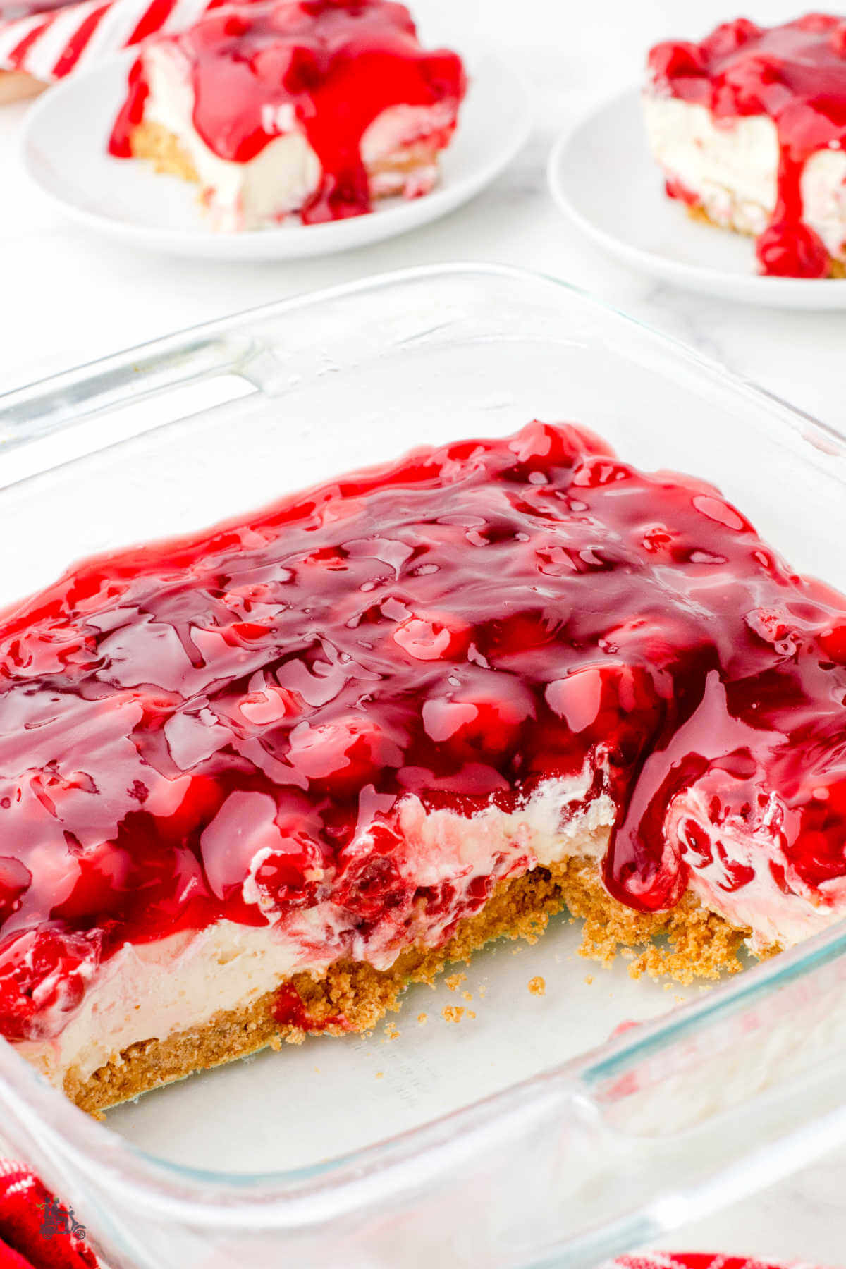 Baking Dish with two servings of Cherry Supreme Dessert plated. 