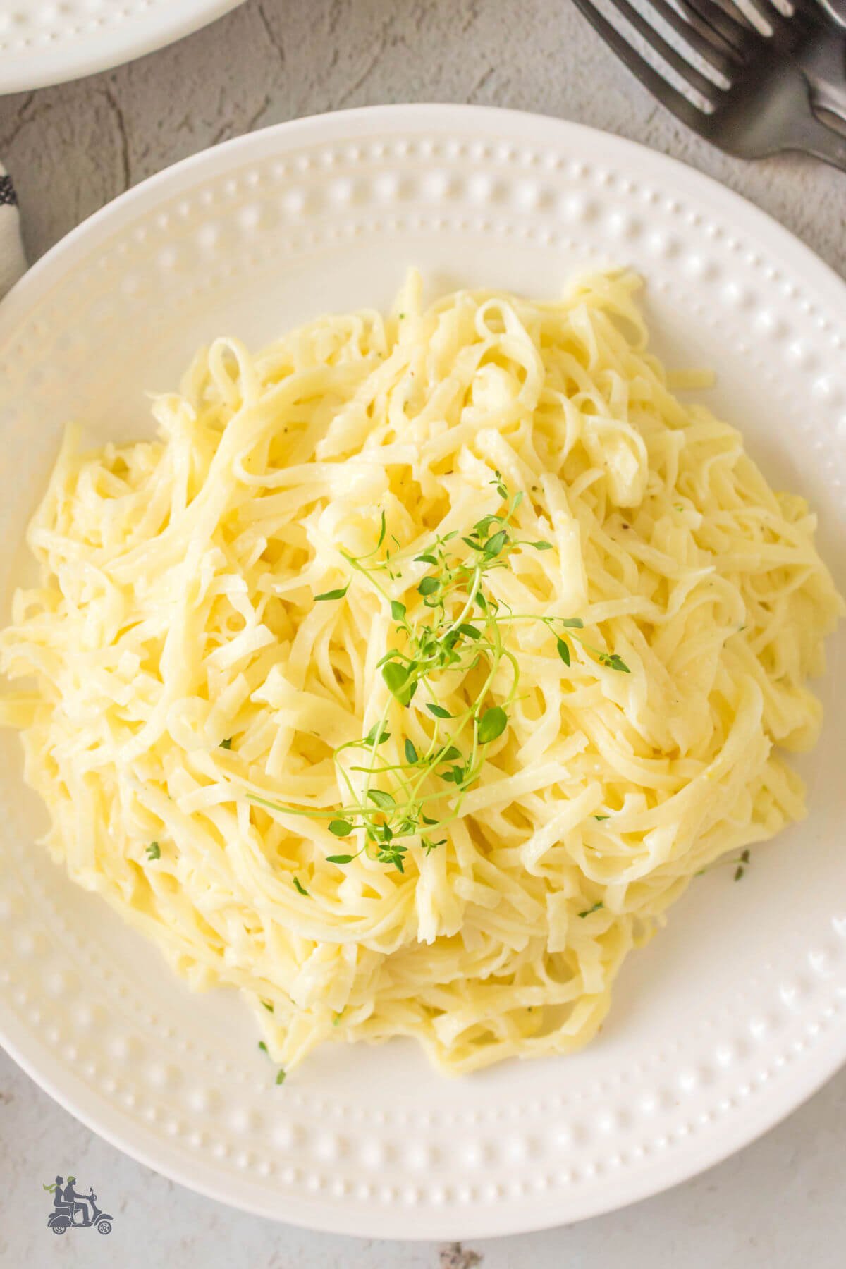 Overhead view of pasta al limone recipe on a white plate. 