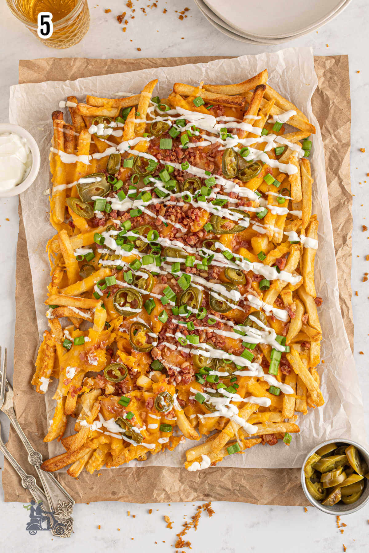 The finished baked loaded french fries topped with sour cream and green onions. 