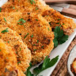 Close up of seasoned breaded pork chops baked in the oven.