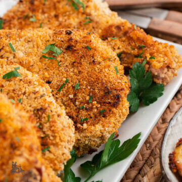 Close up of seasoned breaded pork chops baked in the oven.