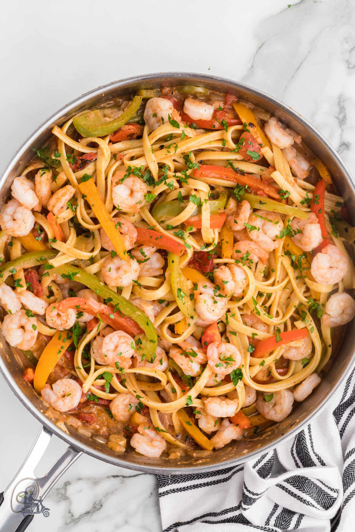 A skillet filled with the pasta and shrimp dish Rasta Pasta. 