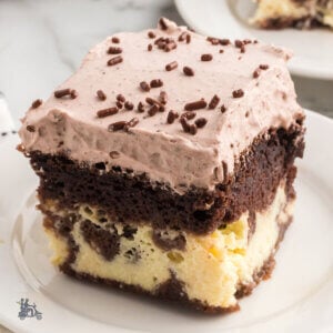 Three layer Italian Love Cake Recipe featuring a ricotta bottom layer, a chocolate cake middle layer, and a creamy fluffy whipped chocolate topping.