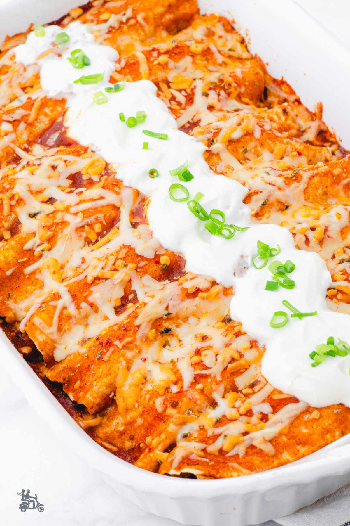 Make ahead breakfast enchiladas filled with sausage and cheese in white baking dish. 