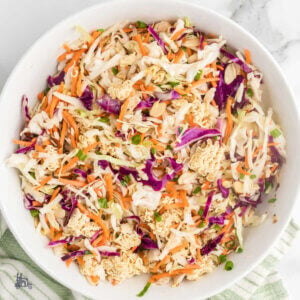 A white bowl filled with coleslaw mix made with ramen noodles.