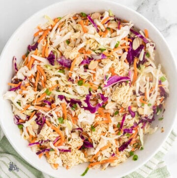 A white bowl filled with coleslaw mix made with ramen noodles.