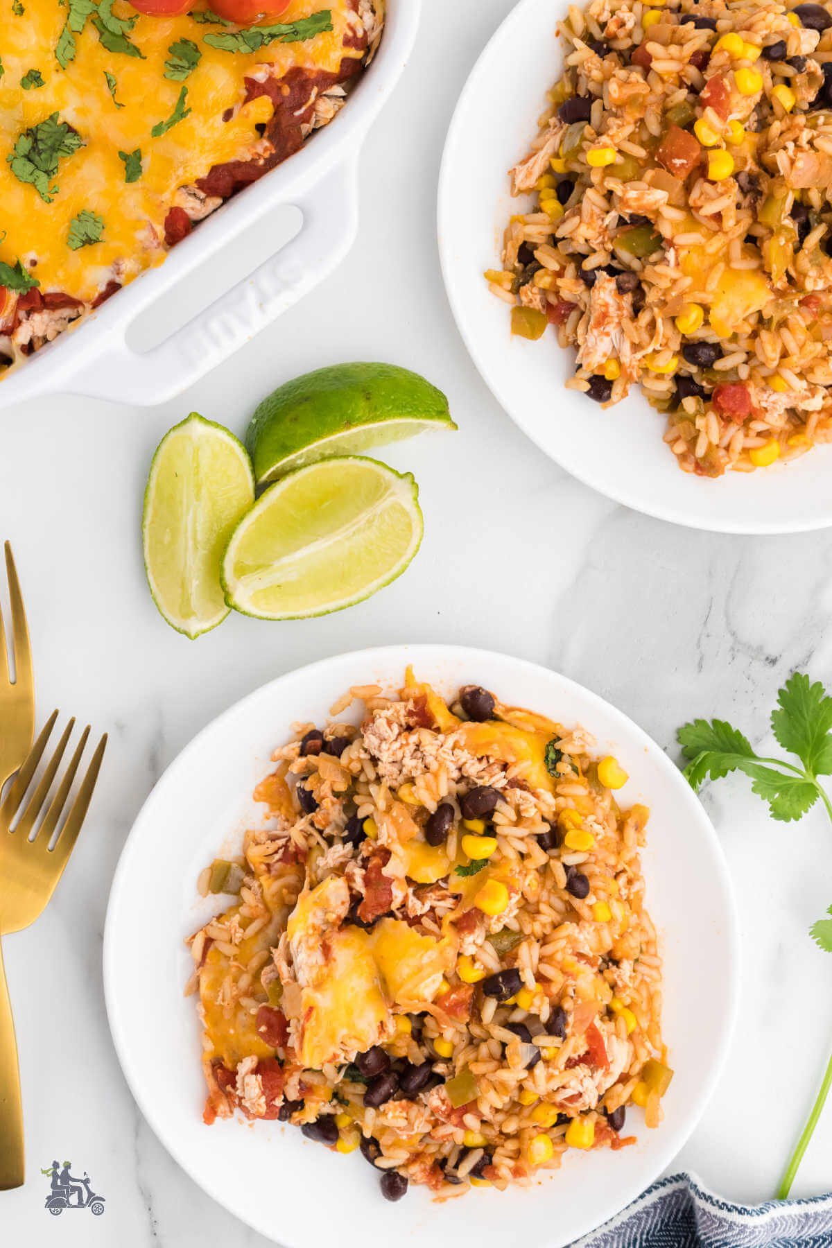 Two servings of the Salsa Chicken and Rice Bake with lime slices on the side. 