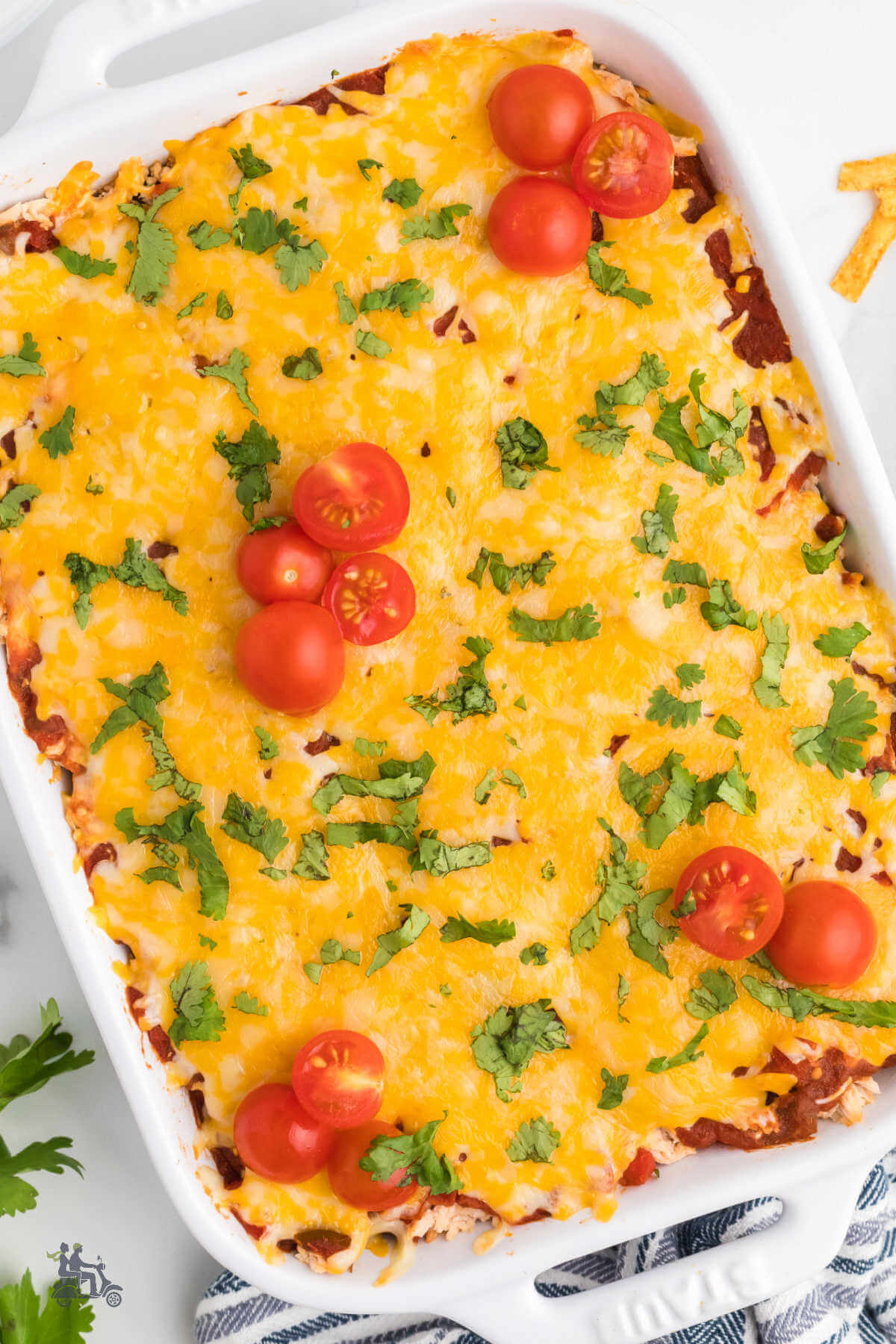 Overhead view of a Mexican flavored chicken and rice casserole with grape tomatoes on top.