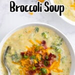 Pinterest image with title overlay for Cheddar Potato And Broccoli Soup with an overhead soup shot with broccoli, cheddar cheese, and green onion garnish.