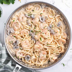 A skillet filled with creamy shrimp pasta recipe with fettuccine noodles.