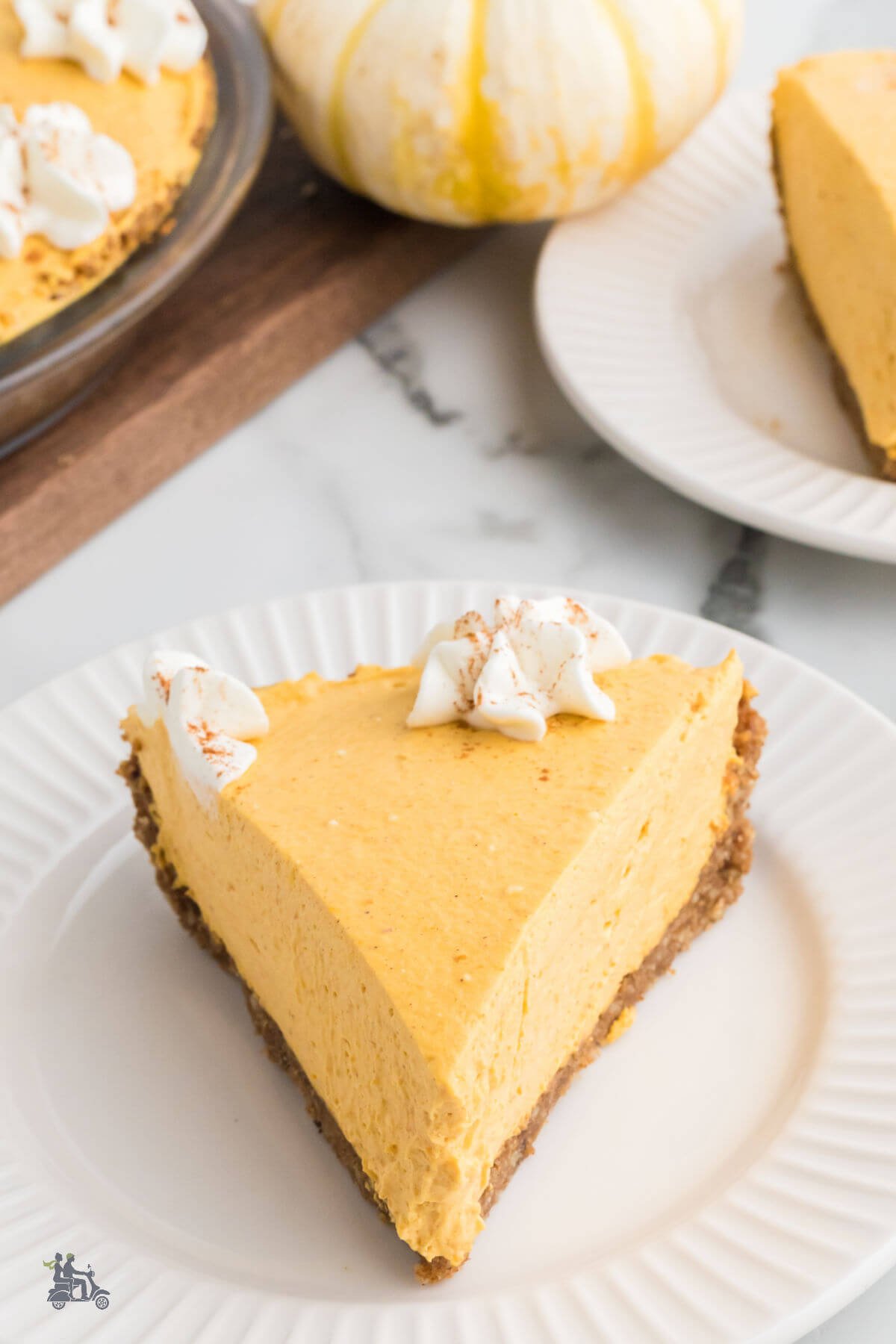 Creamy pumpkin pie that's no bake and made with a gingersnap crust and garnished with whipped cream. 