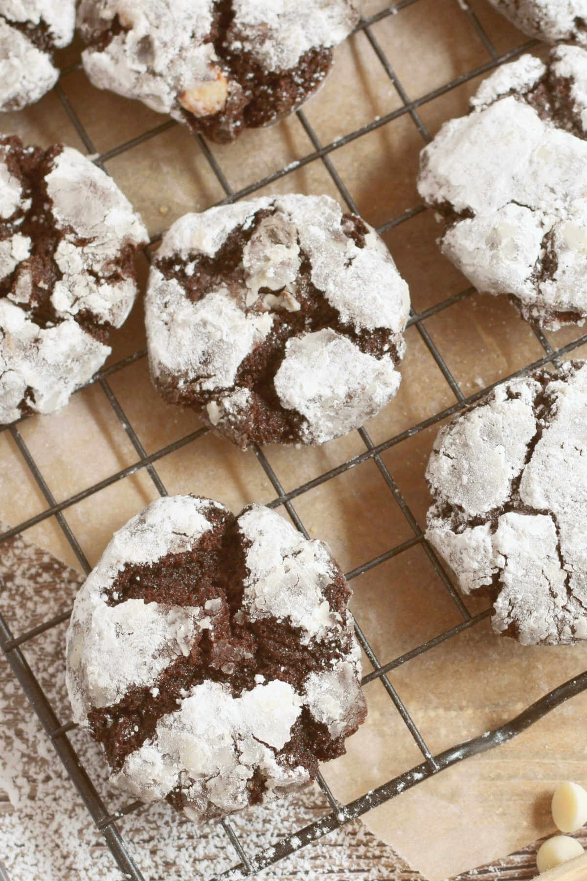 Closeup of the triple chocolate cookies dipped in powdered sugar cooling on a wire rack. 