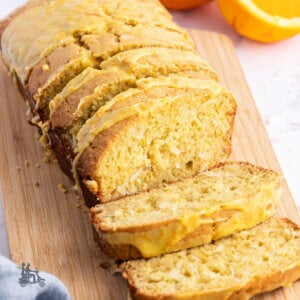 A loaf of quick holiday bread made with coconut, orange flavoring, and macadamia nuts.