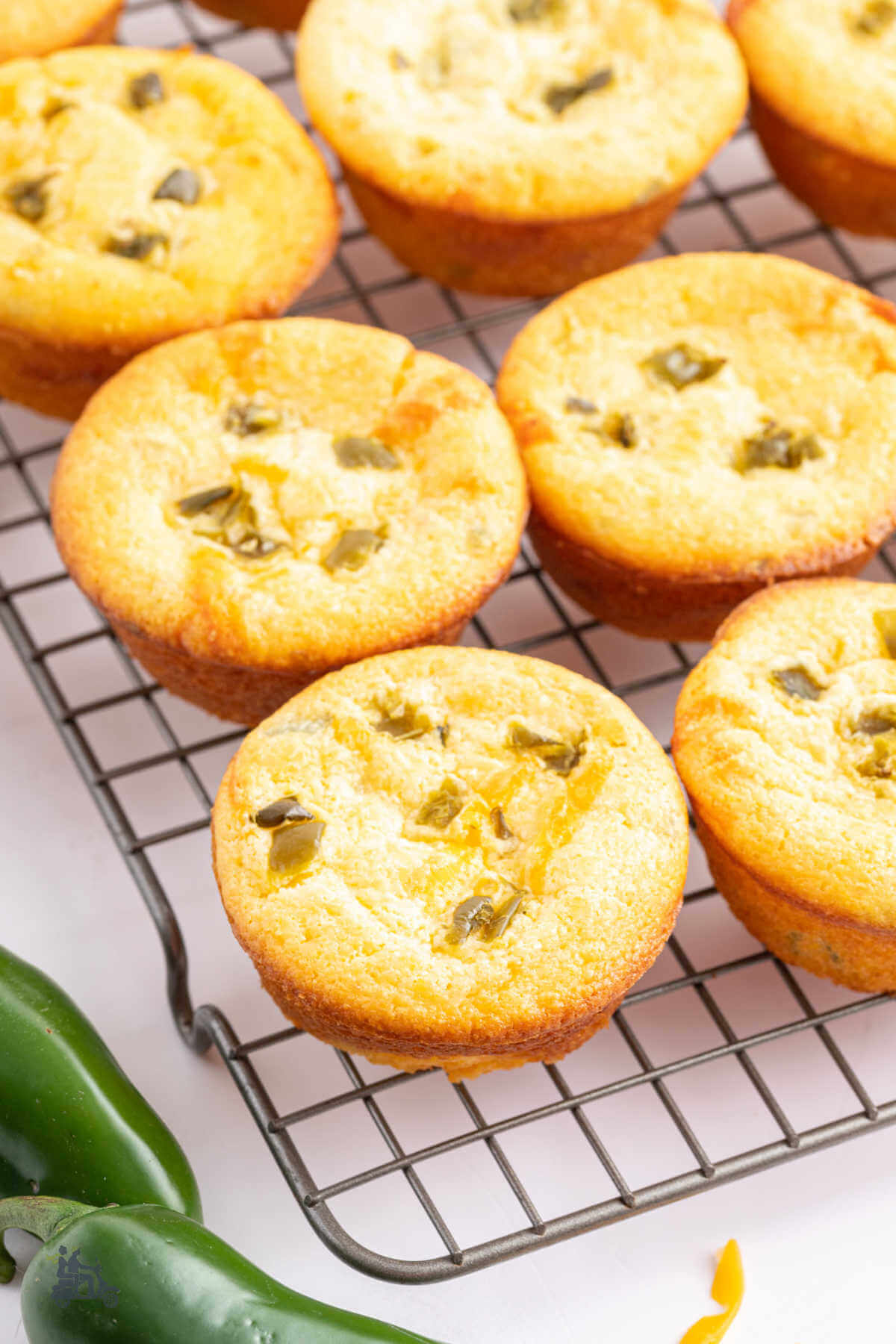 Jiffy Jalapeno Cornbread muffins cooling on a wire rack. 