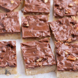 Turtle Caramel Pecan Bars on a white marble counter.