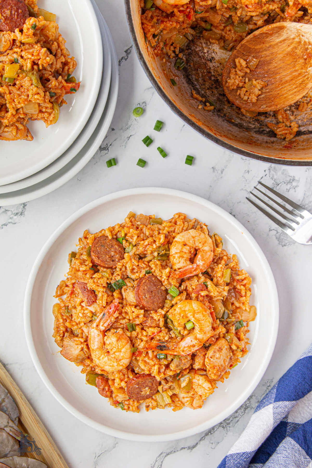 Two bowls filled with Cajun inspired Jambalaya recipe garnished with green onions.