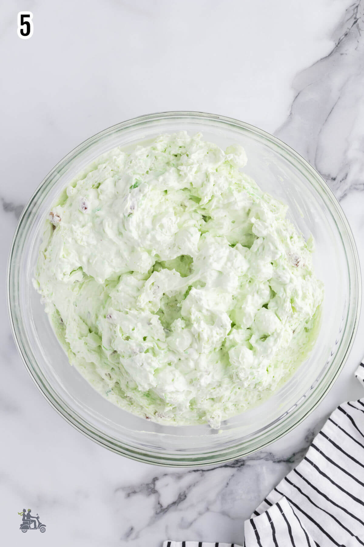 Last step to making the Watergate salad is to add the whipped cream and nuts. 