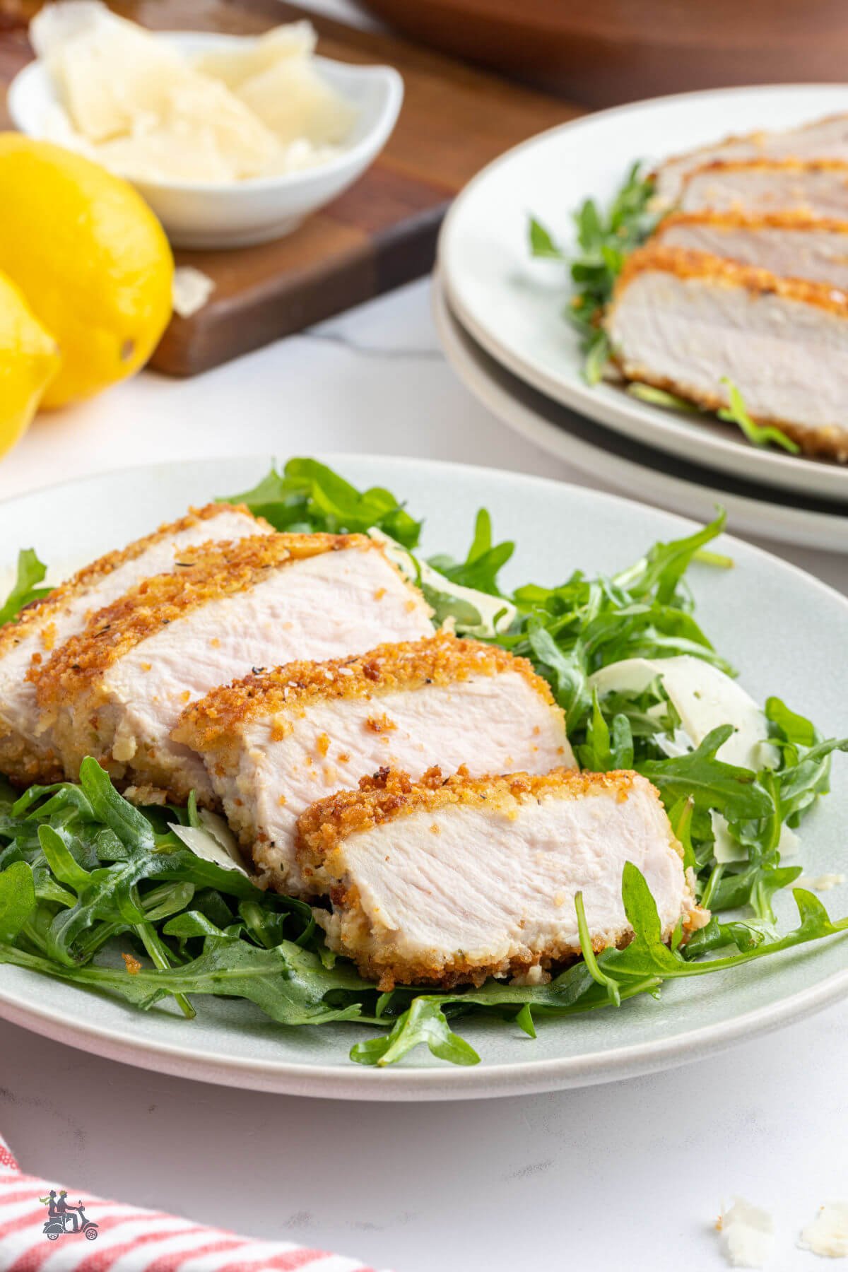 Pork loin chops coated with panko crumbs and fried over a bed of arugula tossed with a lemon vinaigrette. 
