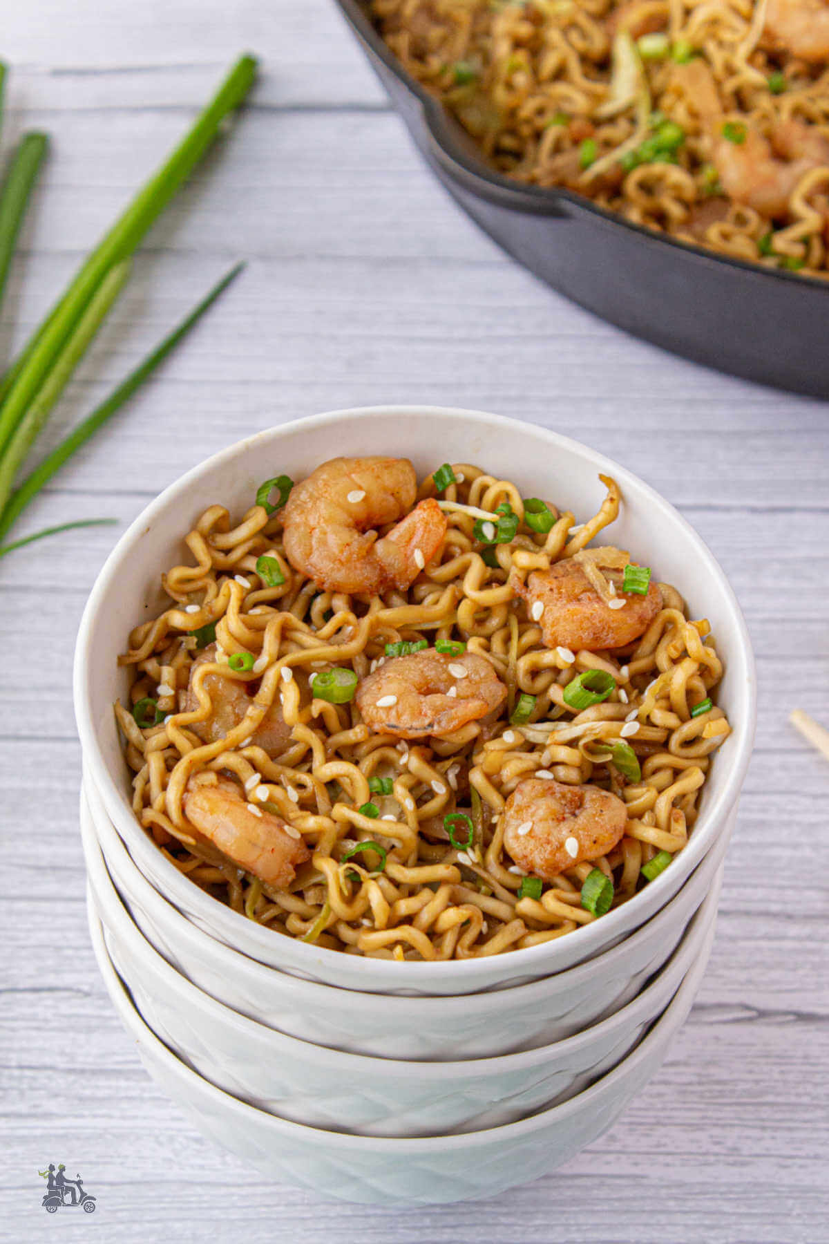 White bowl filled with teriyaki noodles and shrimp. 