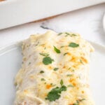 Pinterest Image with title overlay of the white chicken enchilada recipe with cilantro garnish.