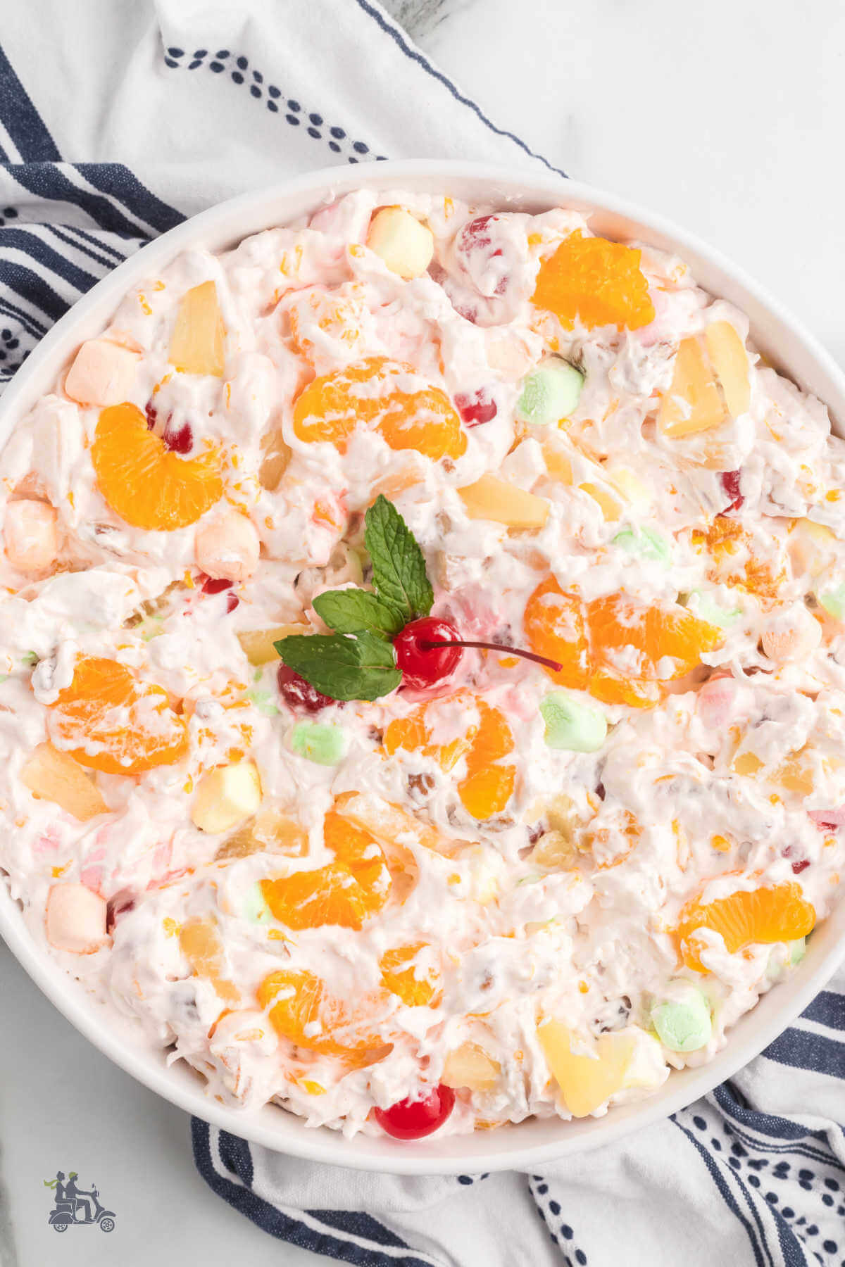 Overhead view of a glass bowl filled with the ambrosia fruit salad with cool whip recipe. 