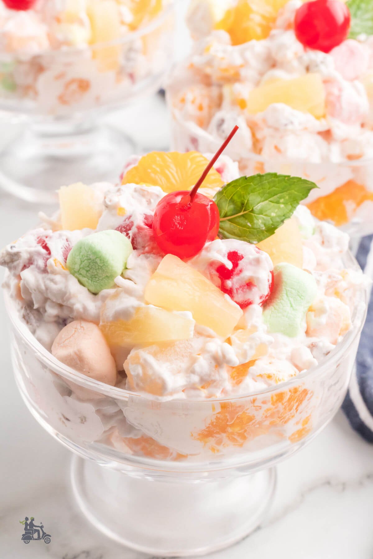 Marshmallow fruit salad with mandarin oranges, pineapple, coconut, pecans, and maraschino cherries. 