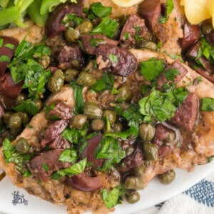 Pork Medallions with Olive Caper Sauce sprinkled with Italian Parsley.