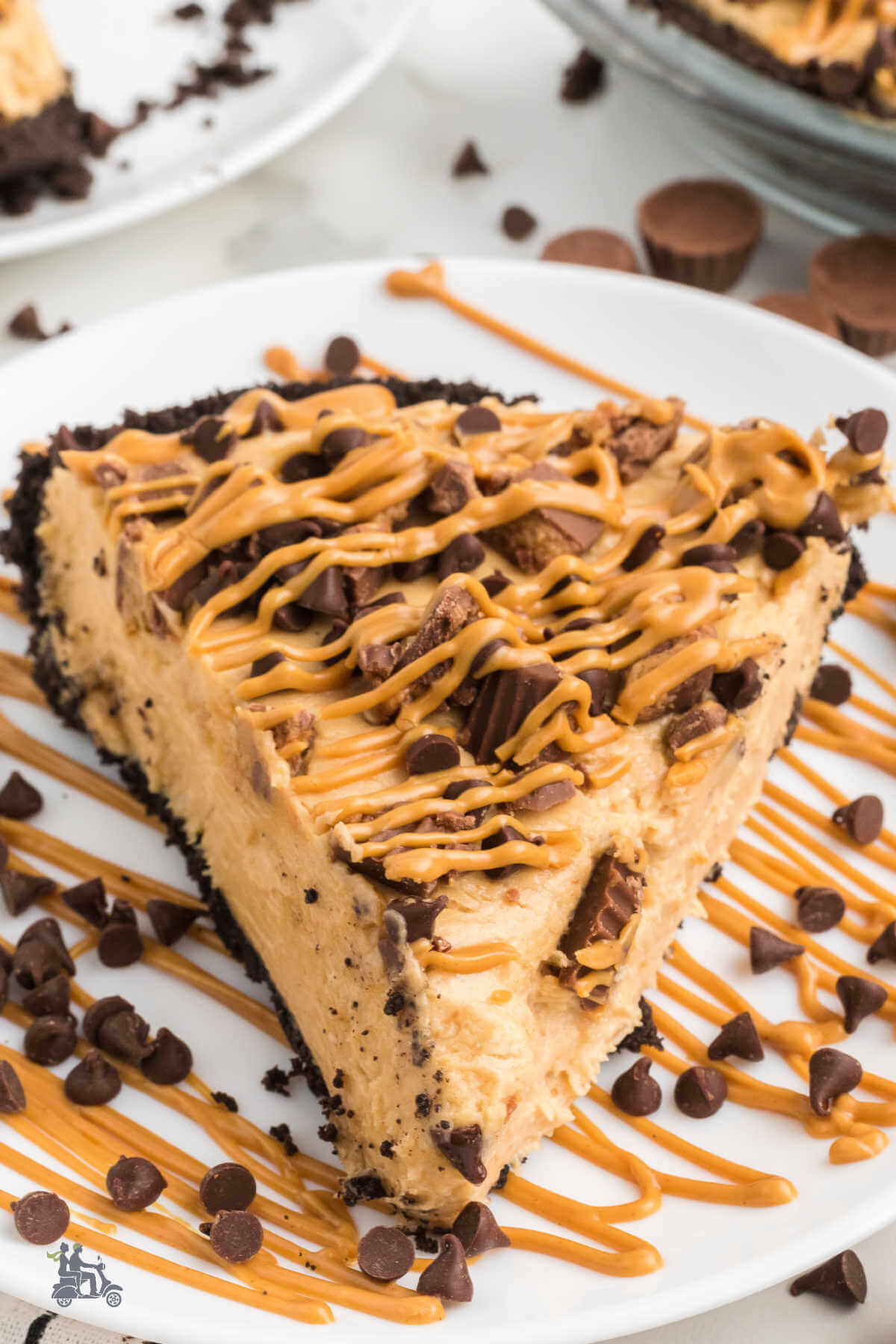 A wedge of a whipped peanut butter pie with Reese's Chocolate pieces scattered on top. 