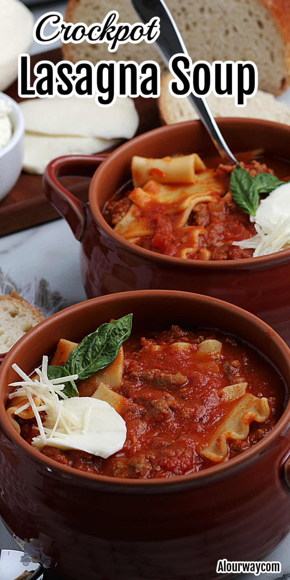 Pinterest image with title overlay of crockpot Lasagna Soup with earthenware bowls filled with the soup and topped with ricotta cheese and basil.