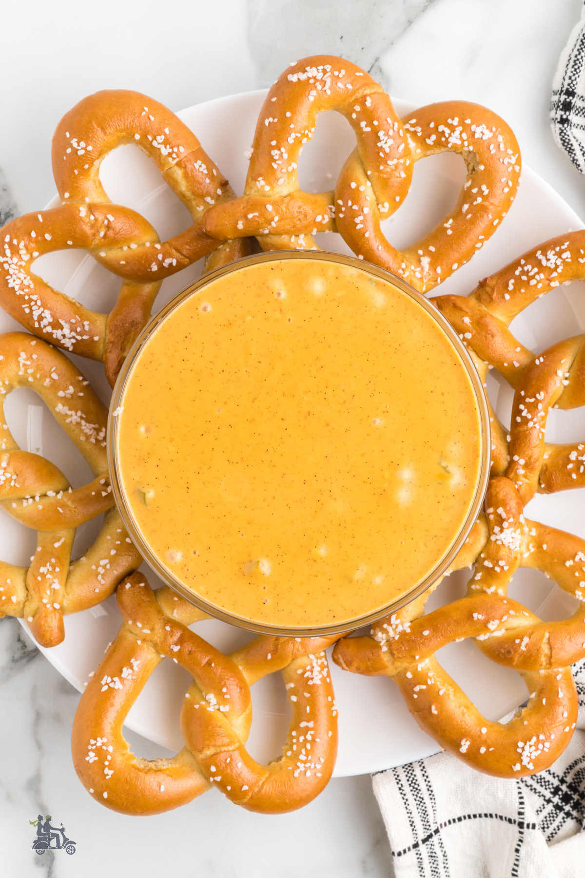 Soft Pretzels surround a bowl of spicy Velveeta dipping sauce. 